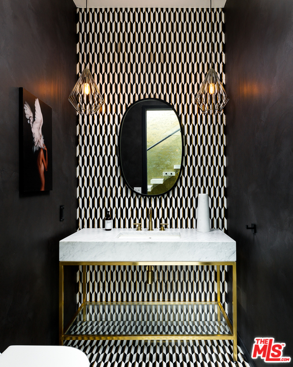 5944 Filaree Heights Road Malibu, CA 90265 - Photo 6 of 33 a bathroom with a sink and a mirror