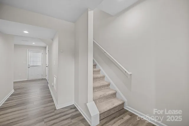 a view of entryway and hall with wooden floor