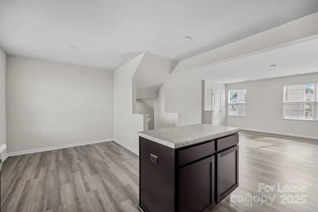 a utility room with wooden floor washer and dryer