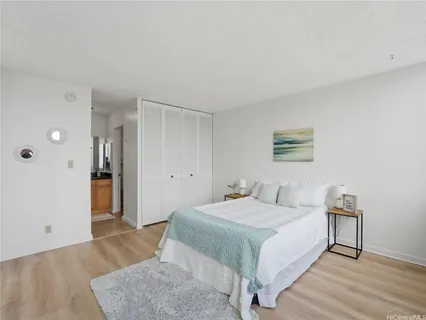a bedroom with a bed and a night stand