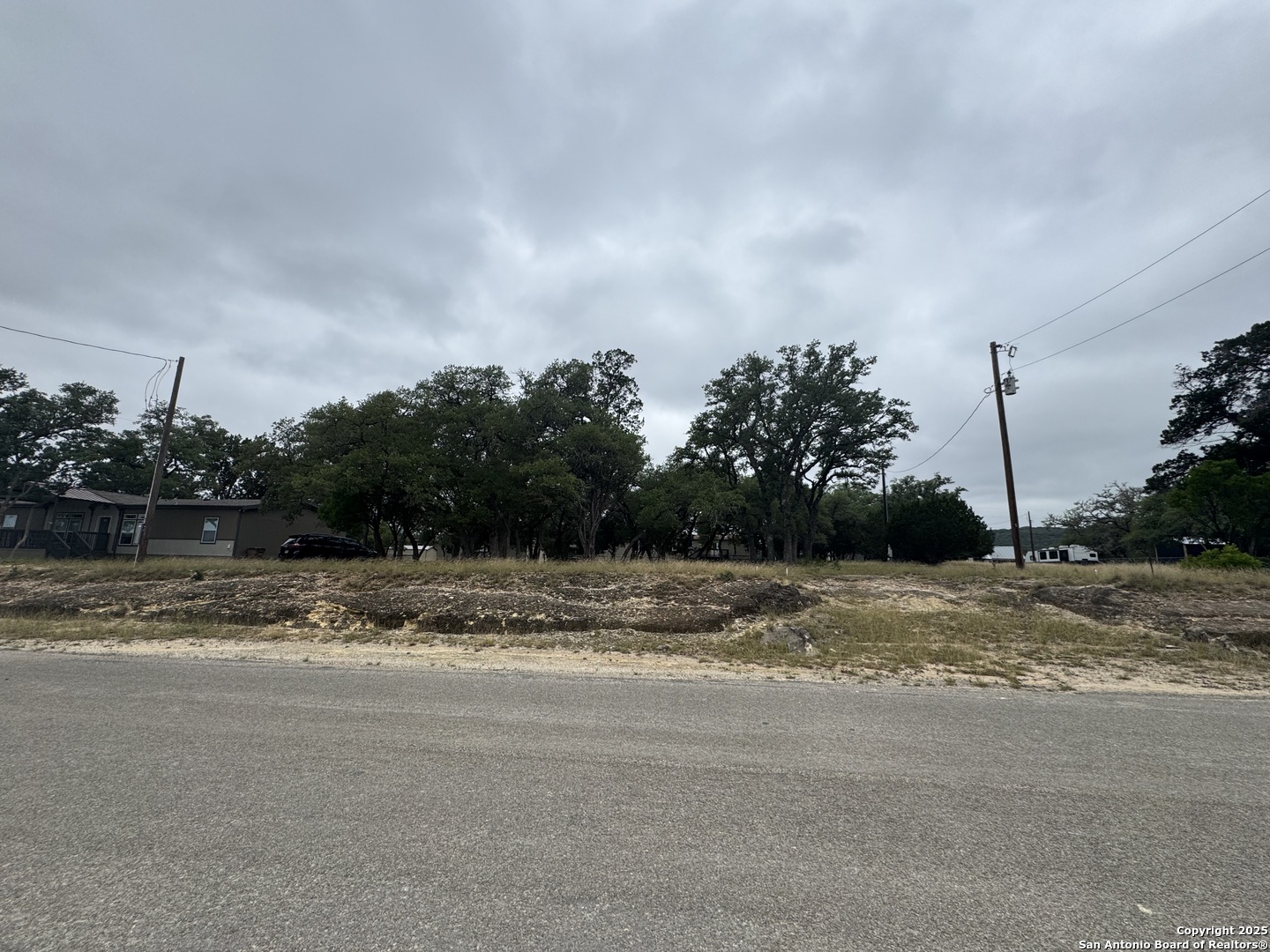 1508 Bandera Bandera, TX 78003 - Photo 6 of 8 a view of a yard with wooden fence