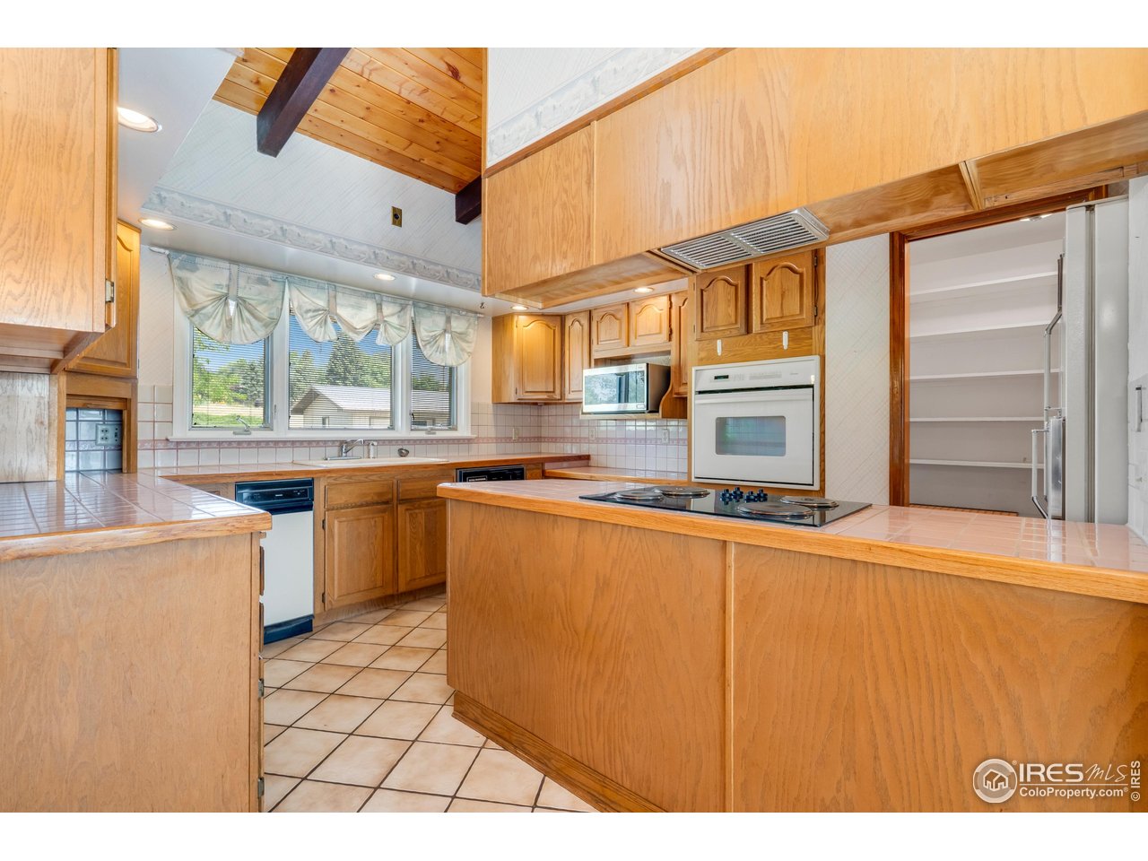 2115 Lindenmeier Road Fort Collins, CO 80524 - Photo 12 of 28 a kitchen with stainless steel appliances a stove a sink and a refrigerator
