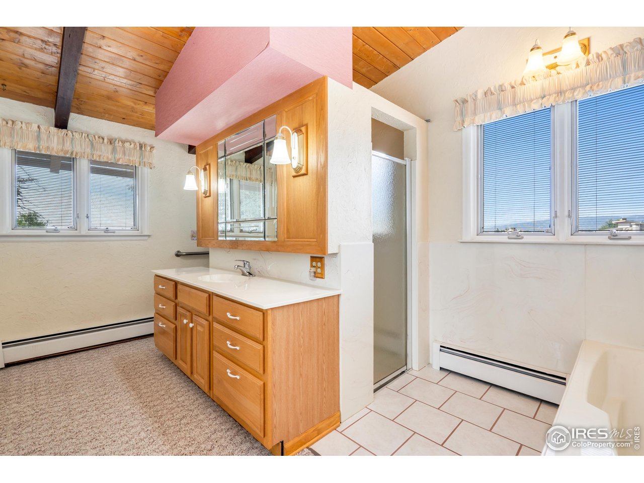 2115 Lindenmeier Road Fort Collins, CO 80524 - Photo 22 of 28 a bathroom with a sink and a mirror