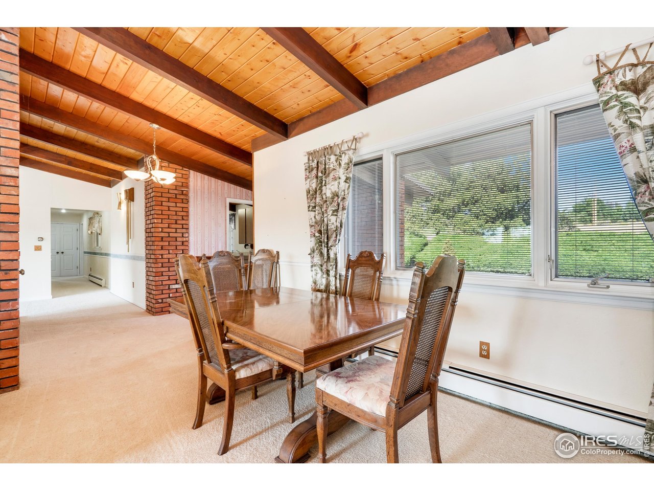 2115 Lindenmeier Road Fort Collins, CO 80524 - Photo 9 of 28 a dining room with furniture and window