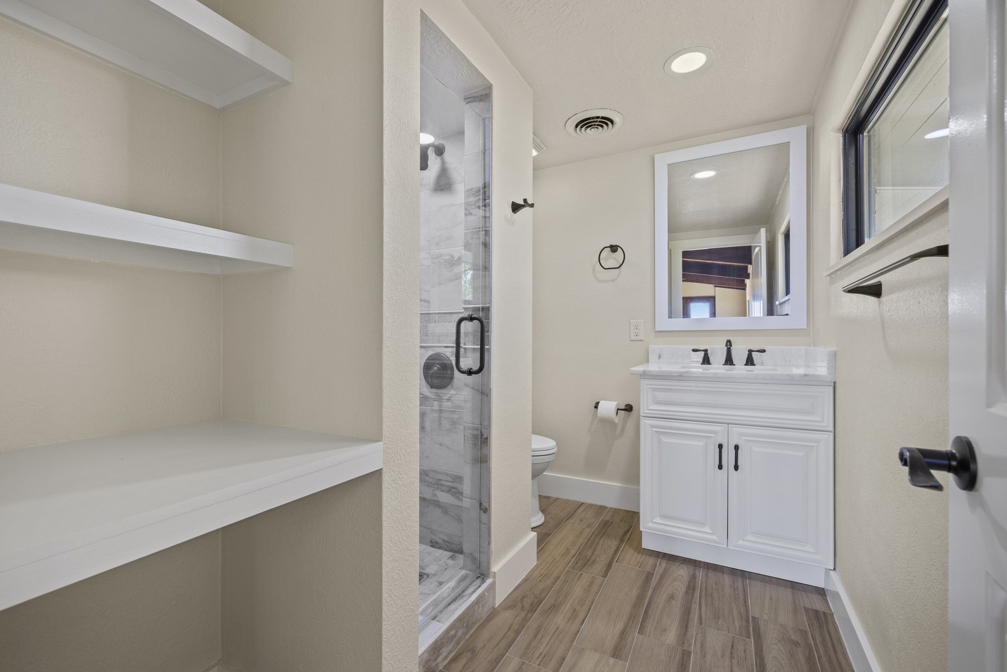 241 Highway 87 Comfort, TX 78013 - Photo 14 of 40 a bathroom with a sink a mirror and shower
