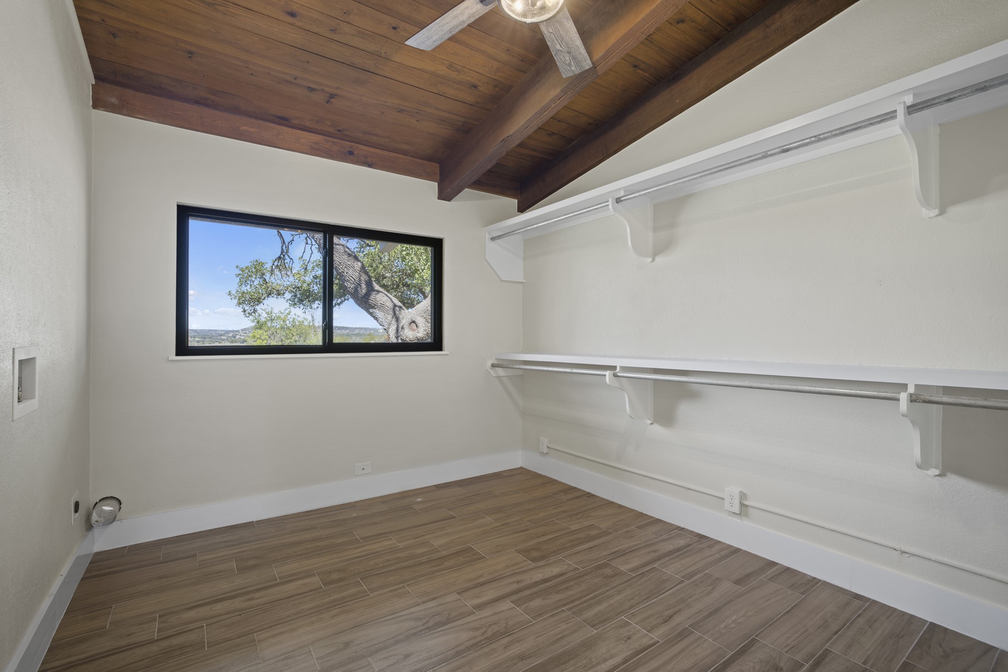 241 Highway 87 Comfort, TX 78013 - Photo 17 of 40 a view of an empty room with wooden floor and window