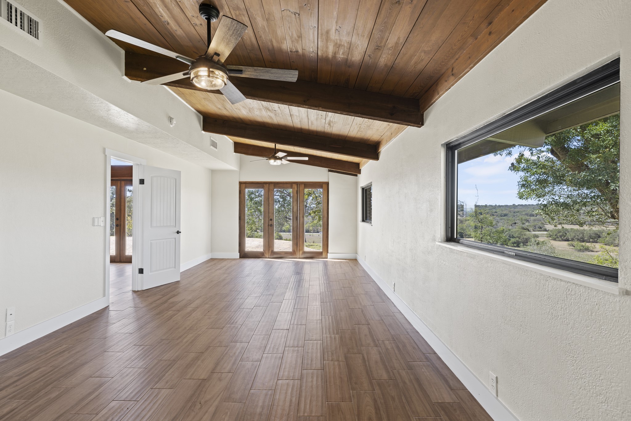 241 Highway 87 Comfort, TX 78013 - Photo 20 of 40 en empty room with wooden floor and windows