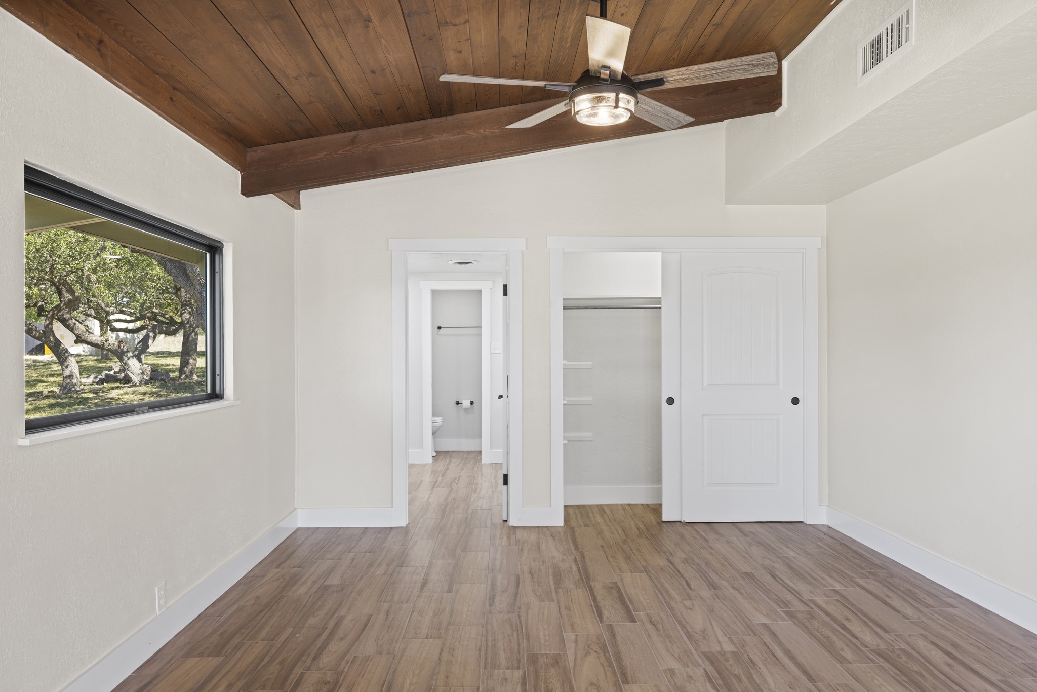 241 Highway 87 Comfort, TX 78013 - Photo 21 of 39 Unfurnished bedroom with wood finished floors, a closet, wooden ceiling, ceiling fan, and ensuite bathroom