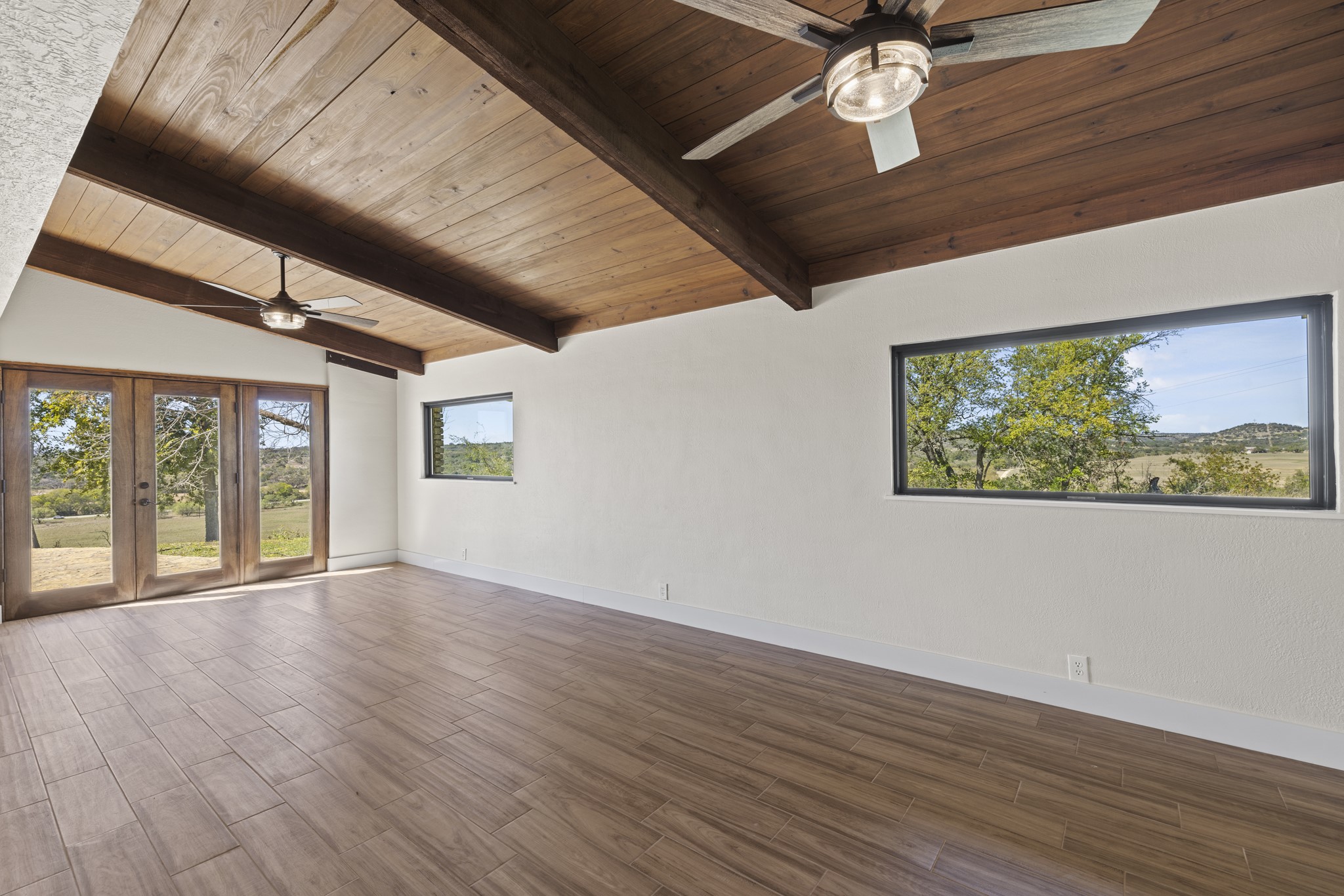 241 Highway 87 Comfort, TX 78013 - Photo 23 of 40 a view of an empty room with wooden floor and a ceiling fan