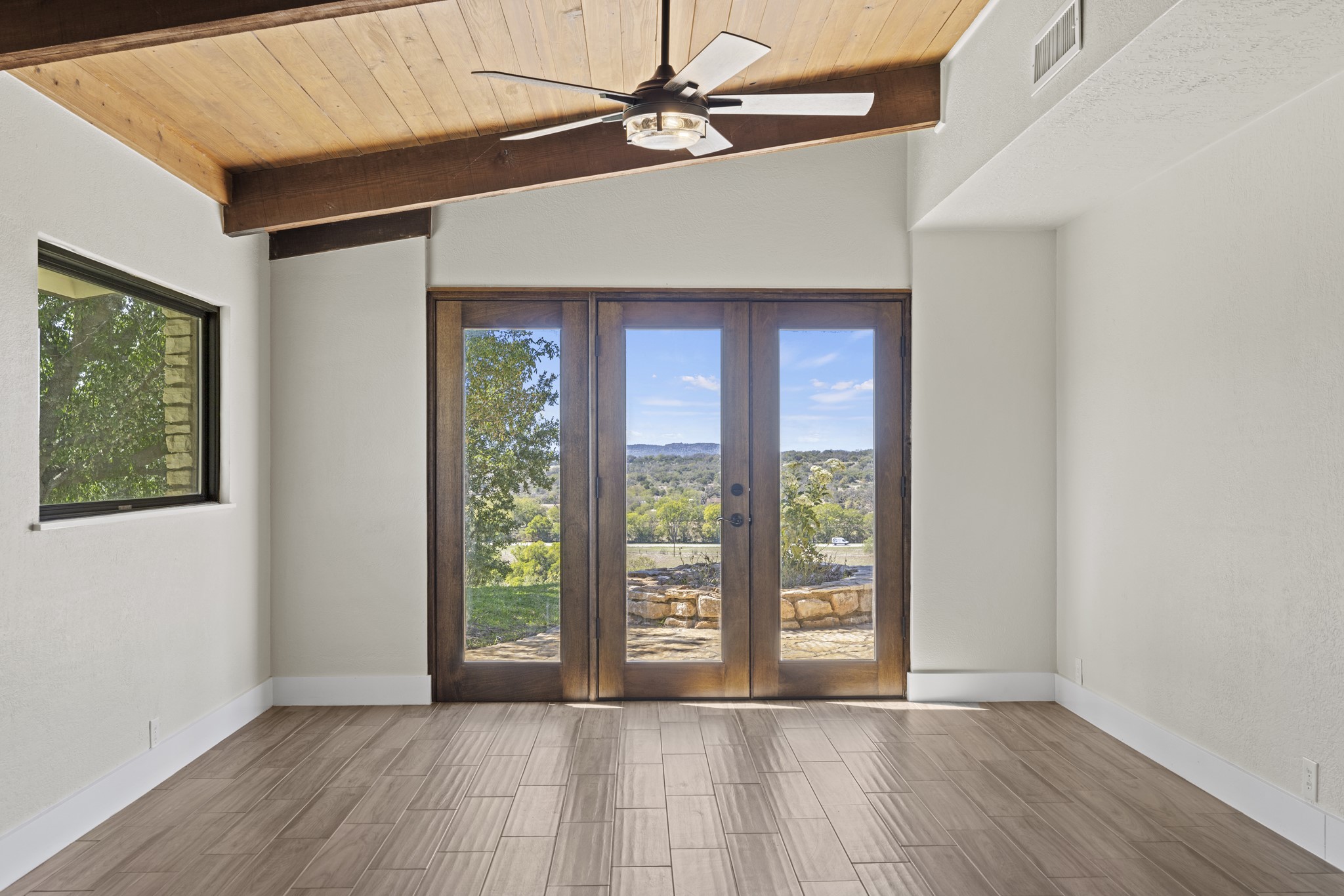241 Highway 87 Comfort, TX 78013 - Photo 10 of 40 a view of an empty room with window and hardwood floor