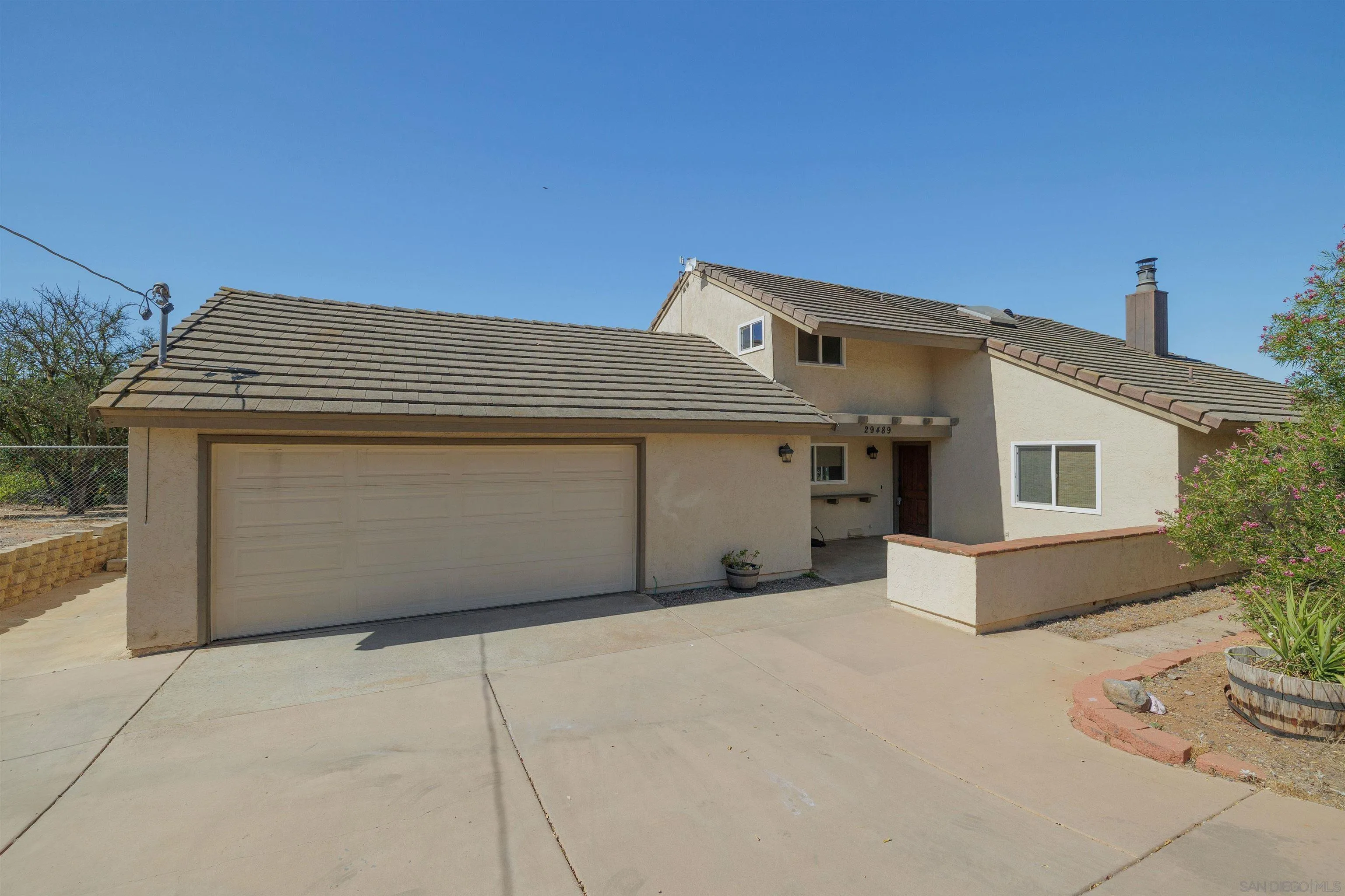 29489 Miller Road Valley Center, CA 92082 - Photo 1 of 30 a front view of a house with a garage