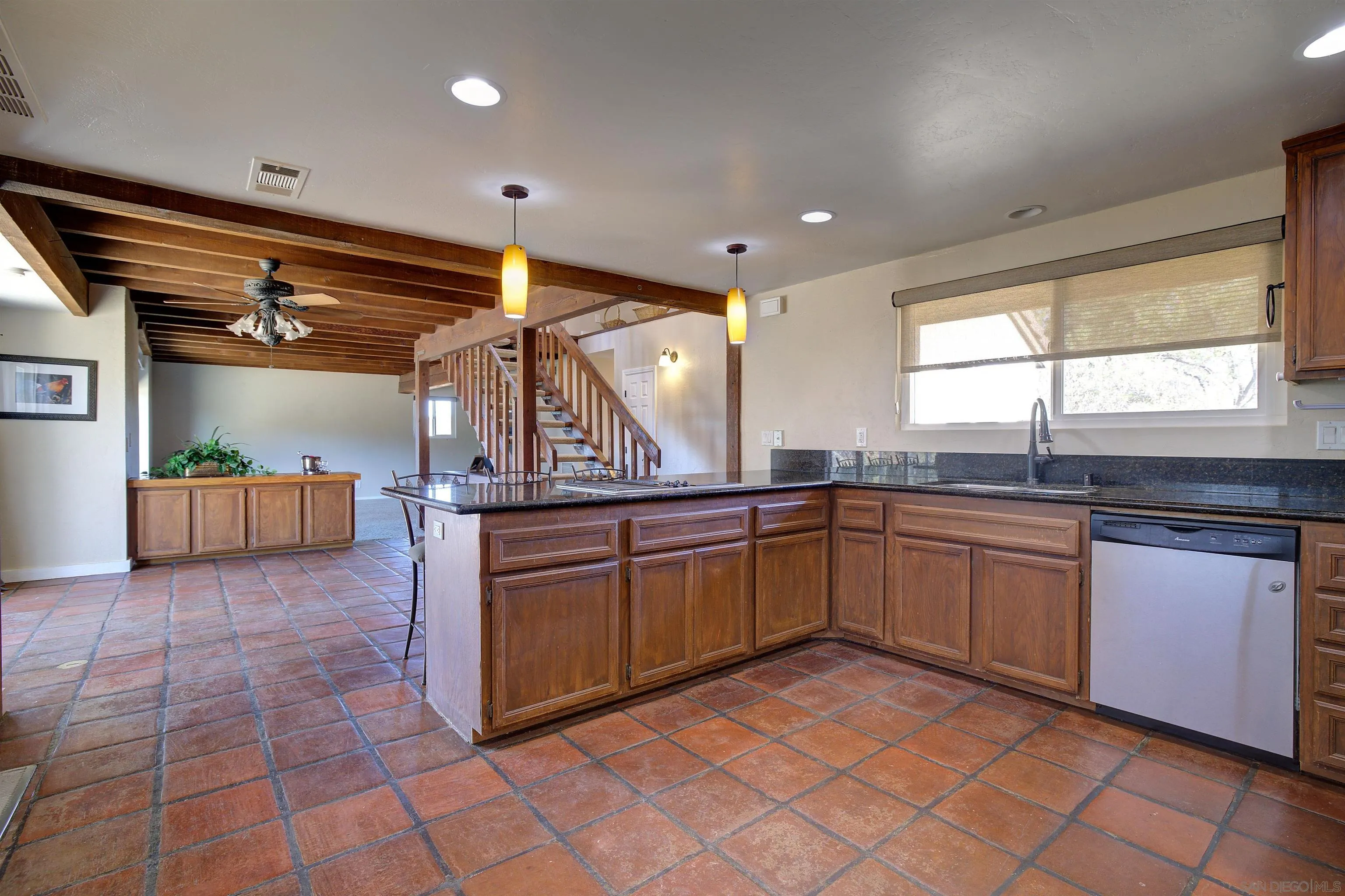 29489 Miller Road Valley Center, CA 92082 - Photo 6 of 30 a large kitchen with kitchen island granite countertop a sink window and stainless steel appliances