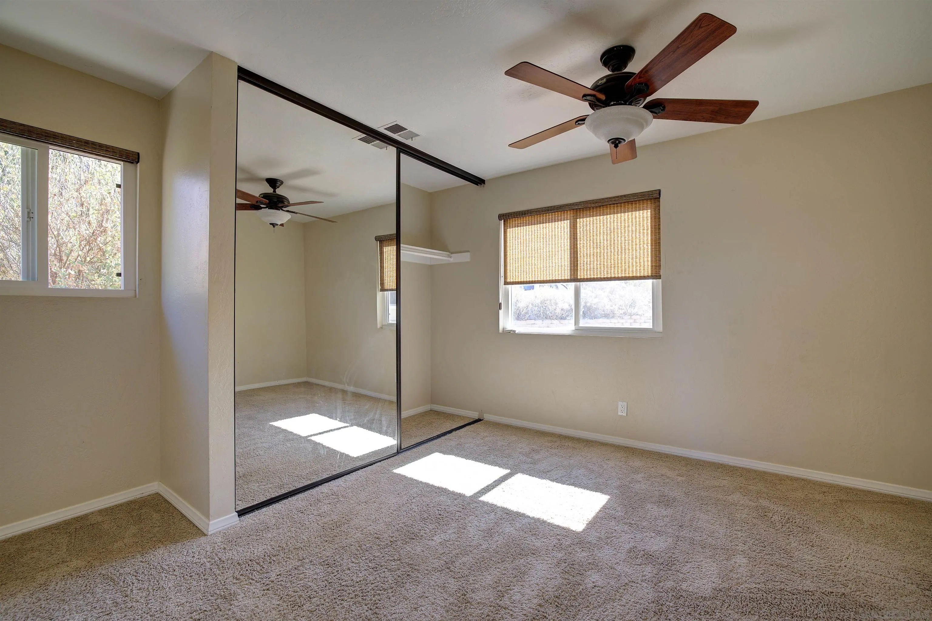 29489 Miller Road Valley Center, CA 92082 - Photo 9 of 30 an empty room with windows and fan