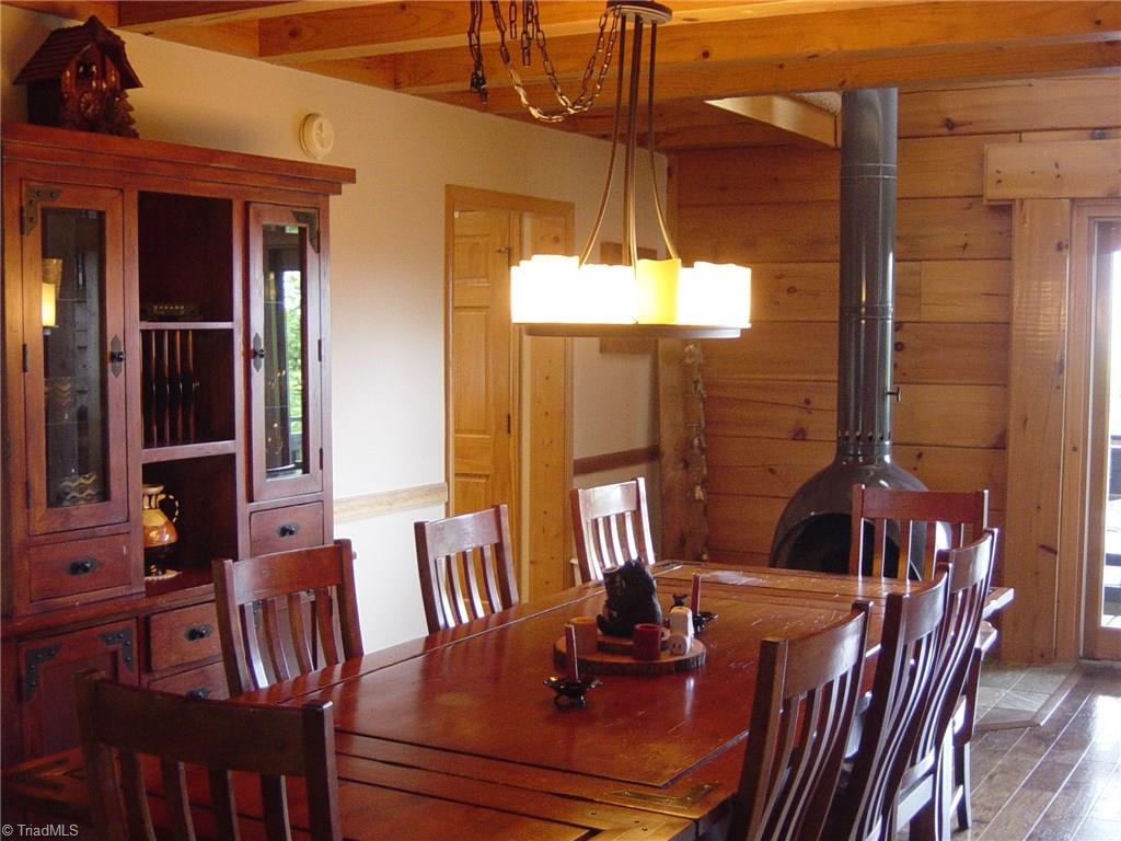 326 Cherokee Lane Purlear, NC 28665 - Photo 14 of 30 Dining room has freestanding wood burning fireplace for those cozy dinners.