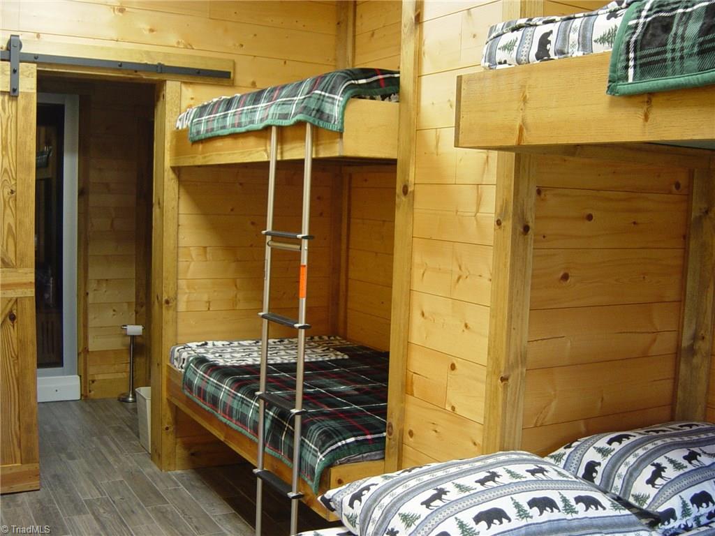 326 Cherokee Lane Purlear, NC 28665 - Photo 23 of 30 Lower level bedroom has 4 built-in bunks with barn door. Has it's own full bath too with fabulous shower.