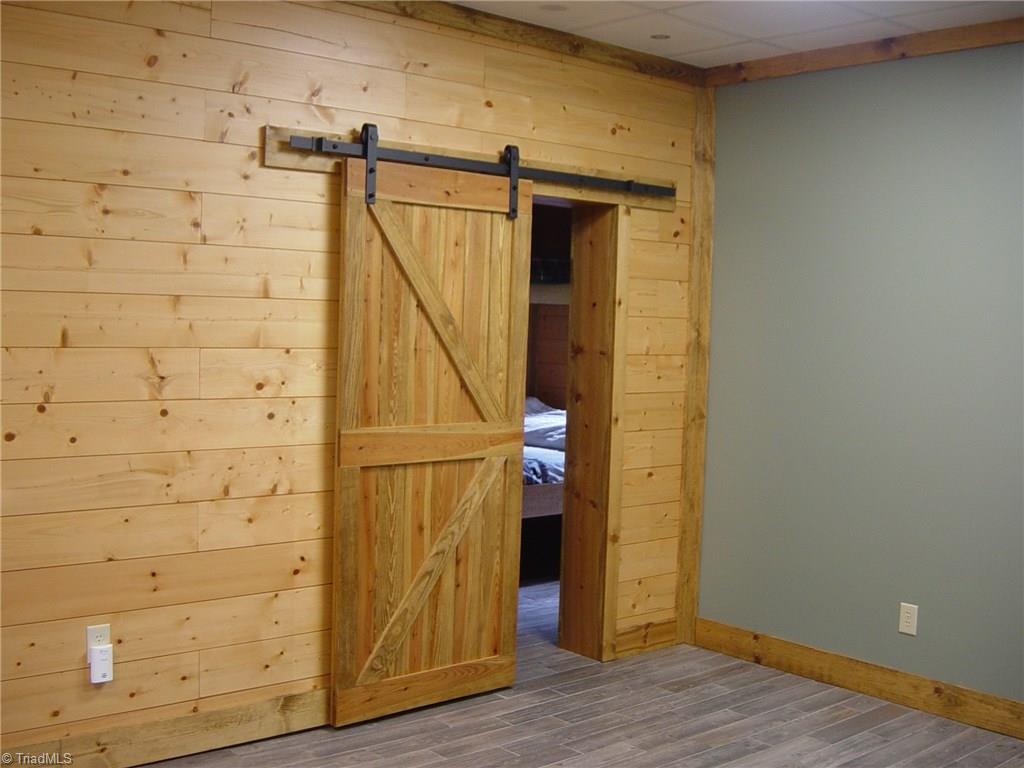 326 Cherokee Lane Purlear, NC 28665 - Photo 25 of 30 Lower level family room with barn door.