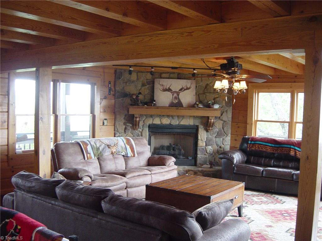 326 Cherokee Lane Purlear, NC 28665 - Photo 10 of 30 Living room features rock fireplace , wood floors, plenty of windows to enjoy views.
