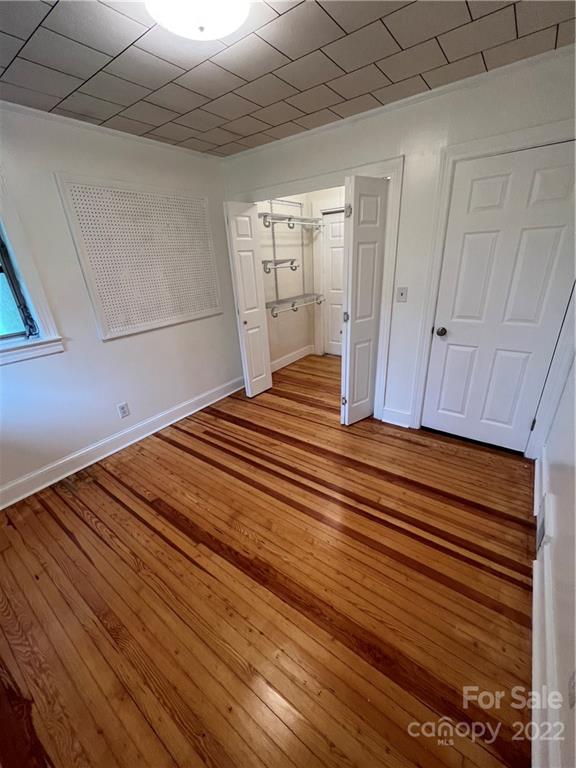 280 Stone Road, Unit 16 Salisbury, NC 28146 - Photo 19 of 25 a bedroom with a bed and wooden floor