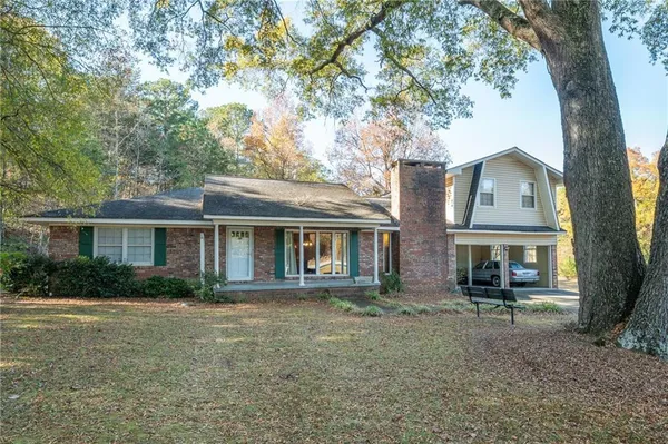 front view of a house with a tree