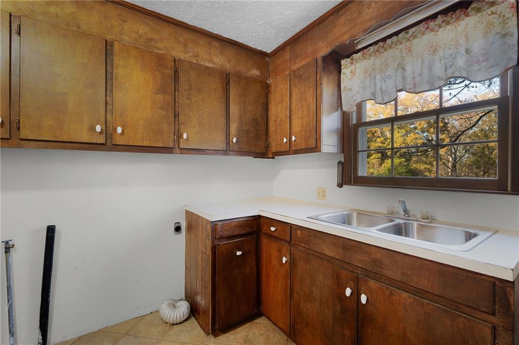 3293 Rome Road Southwest Plainville, GA 30733 - Photo 16 of 42 a bathroom with a sink and a mirror