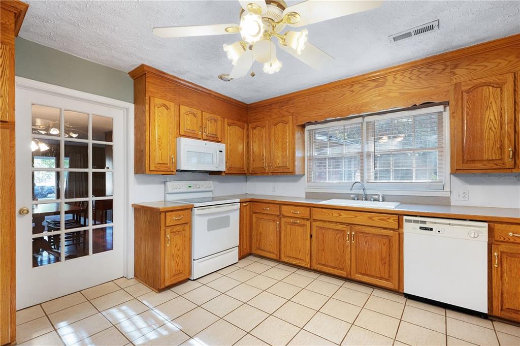 3293 Rome Road Southwest Plainville, GA 30733 - Photo 20 of 42 a kitchen with granite countertop sink cabinets and window