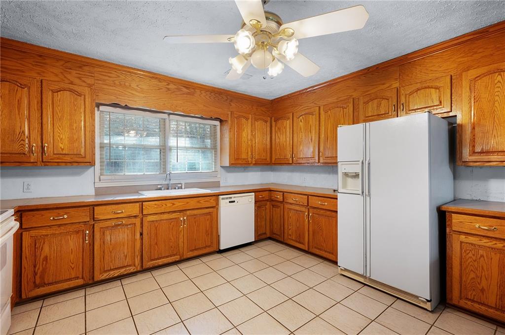 3293 Rome Road Southwest Plainville, GA 30733 - Photo 21 of 42 a kitchen with granite countertop cabinets and refrigerator