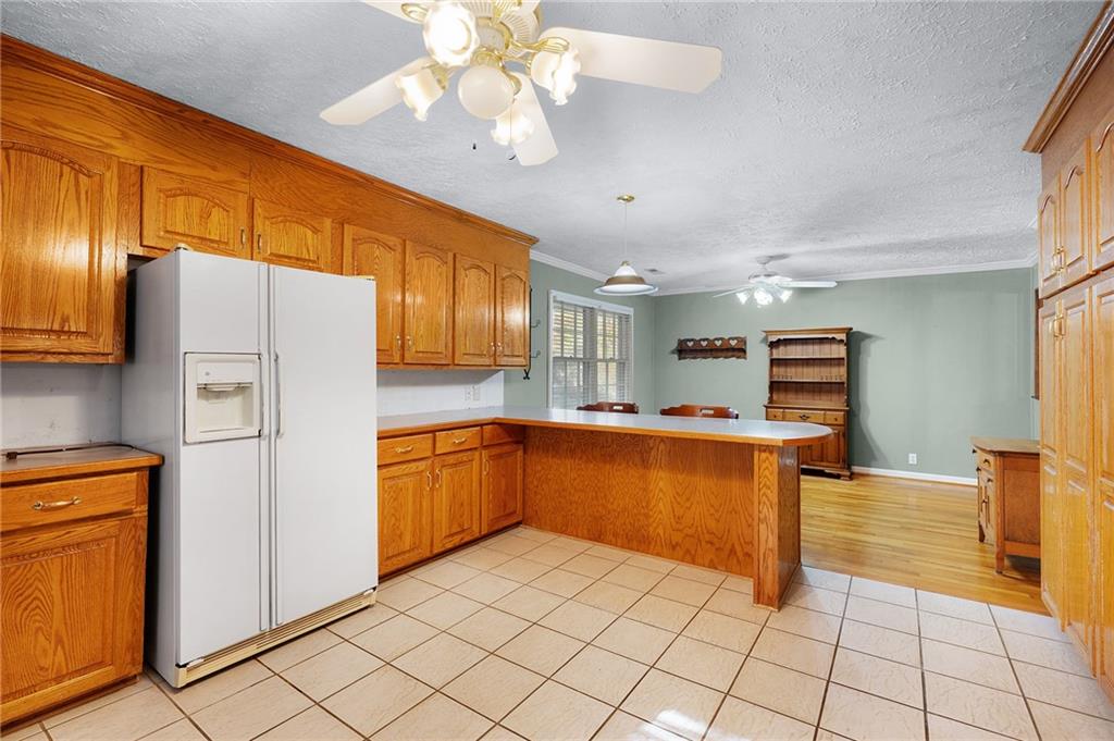 3293 Rome Road Southwest Plainville, GA 30733 - Photo 23 of 42 a kitchen with stainless steel appliances granite countertop a refrigerator and a sink