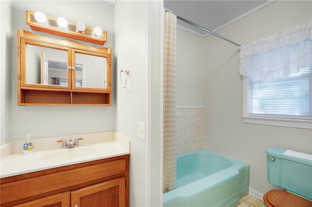 3293 Rome Road Southwest Plainville, GA 30733 - Photo 29 of 42 a bathroom with a tub a sink and a window