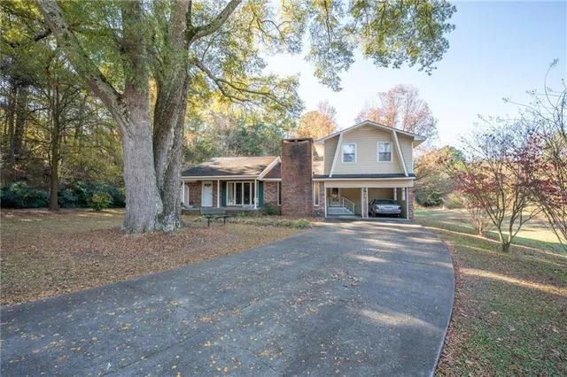 a front view of a house with a garden