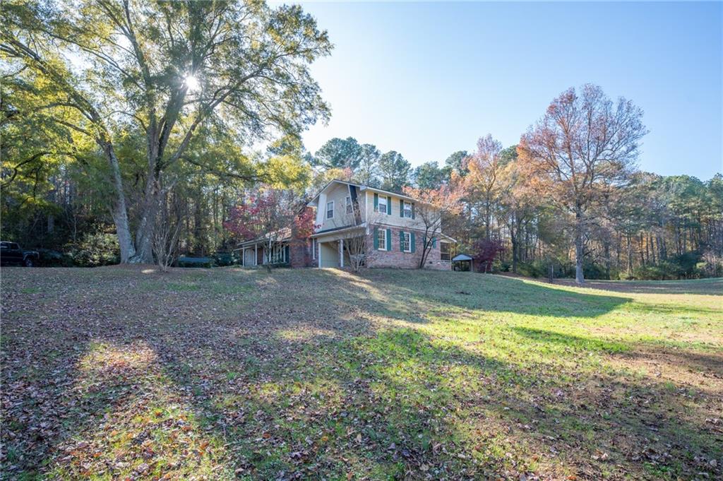 3293 Rome Road Southwest Plainville, GA 30733 - Photo 38 of 42 a view of a house with swimming pool next to a yard