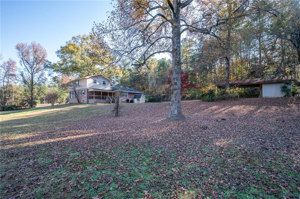 3293 Rome Road Southwest Plainville, GA 30733 - Photo 40 of 42 a view of a tree in front of a house