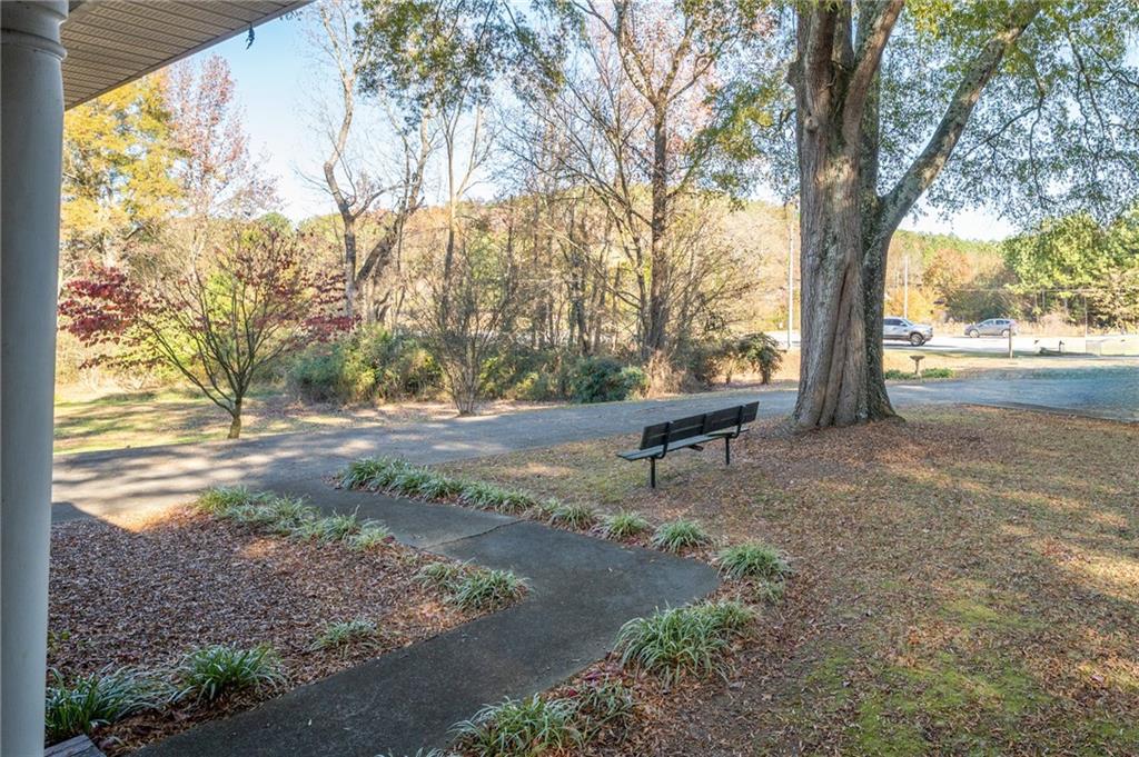 3293 Rome Road Southwest Plainville, GA 30733 - Photo 5 of 42 a backyard of a house with yard and outdoor seating