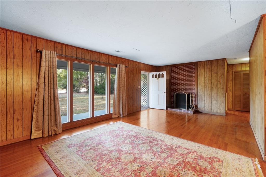 3293 Rome Road Southwest Plainville, GA 30733 - Photo 8 of 42 a view of an empty room with window and wooden floor