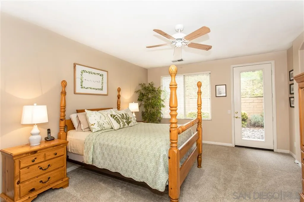 805 La Rue Avenue Fallbrook, CA 92028 - Photo 11 of 25 a bedroom with a bed and a chandelier