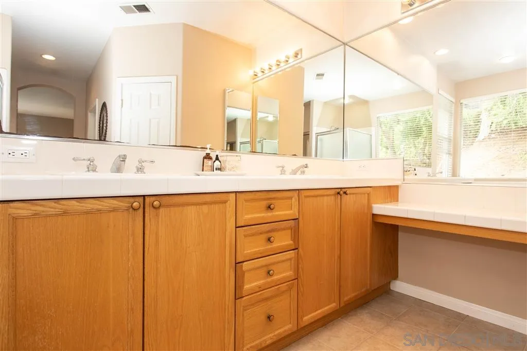 805 La Rue Avenue Fallbrook, CA 92028 - Photo 12 of 25 a bathroom with a double vanity sink and mirror