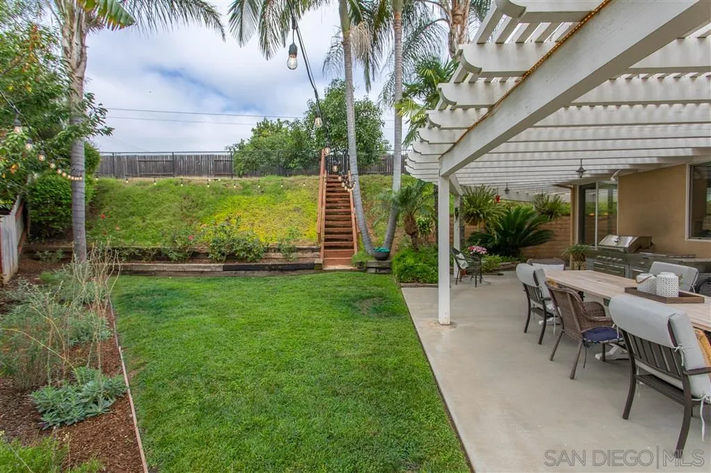 805 La Rue Avenue Fallbrook, CA 92028 - Photo 19 of 25 a view of a backyard with table and chairs potted plants and palm trees