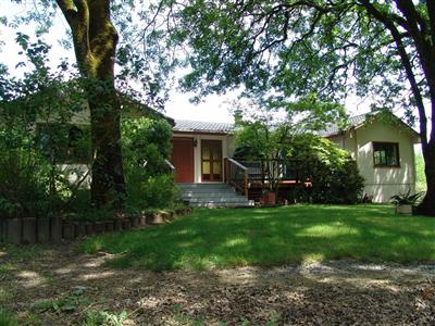 a view of a house with backyard porch and sitting area