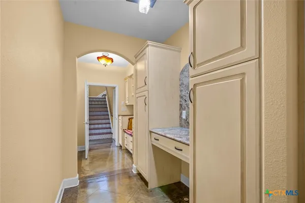 a view of hallway with stairs and wooden floor