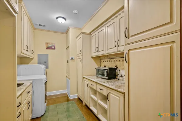 a kitchen with stainless steel appliances granite countertop a refrigerator and a stove