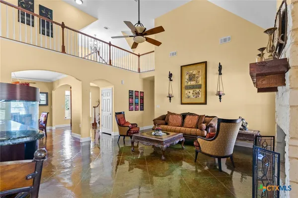 a living room with furniture a rug and a chandelier