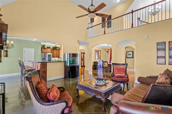 a living room with furniture a rug and a table