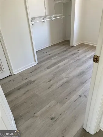 a view of a room with wooden floor