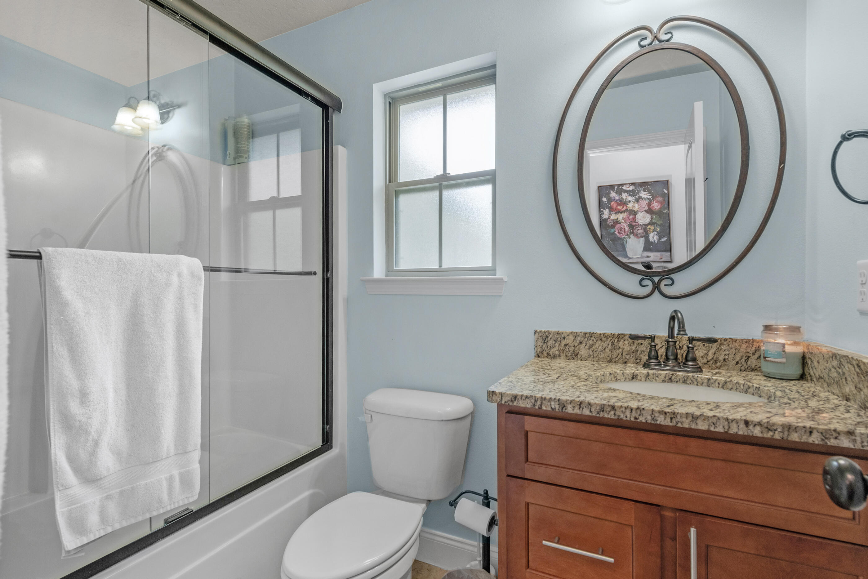 4509 Beth Circle Crestview, FL 32539 - Photo 16 of 29 a bathroom with a granite countertop toilet sink and mirror