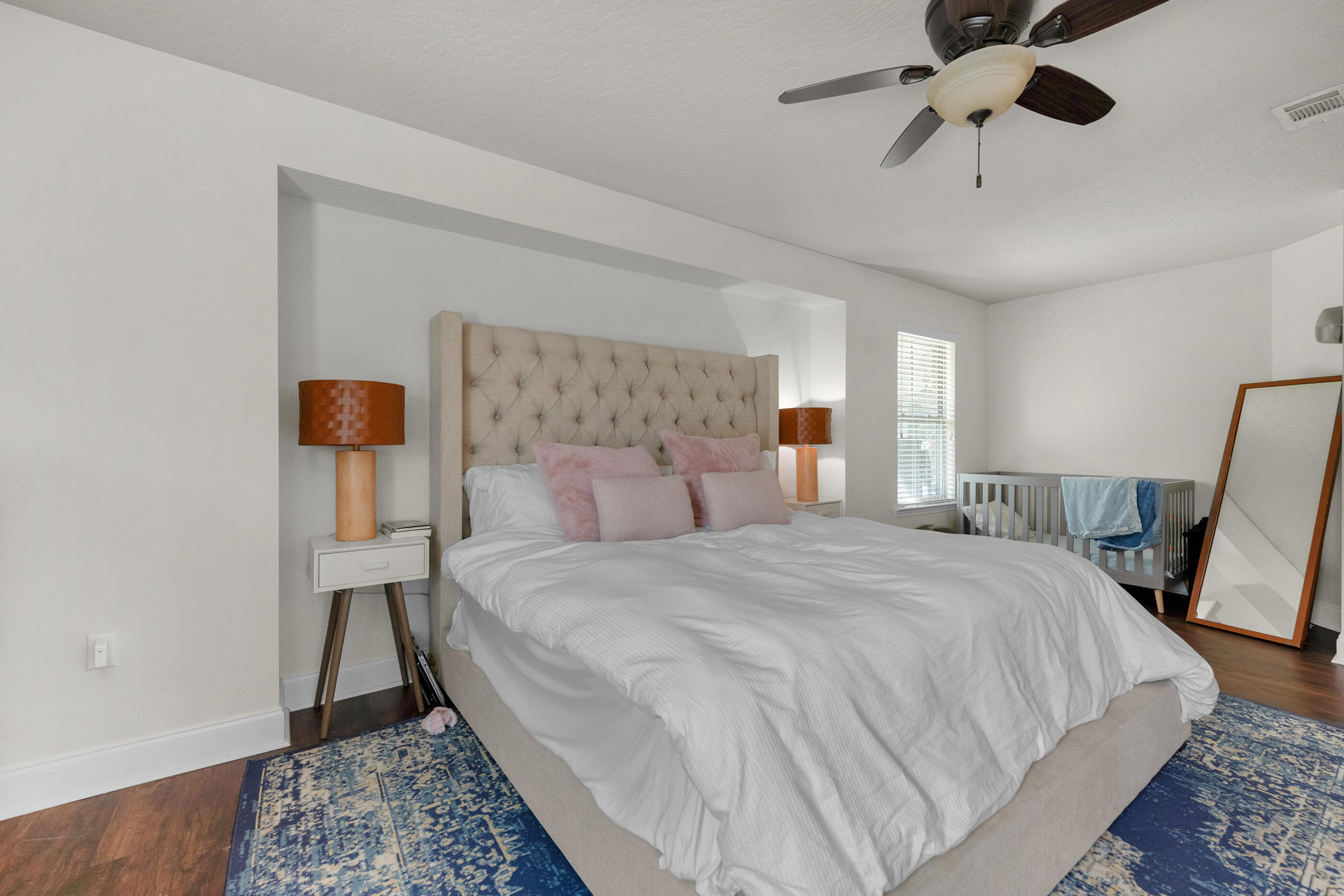 4509 Beth Circle Crestview, FL 32539 - Photo 18 of 29 a bedroom with a bed and wooden floor