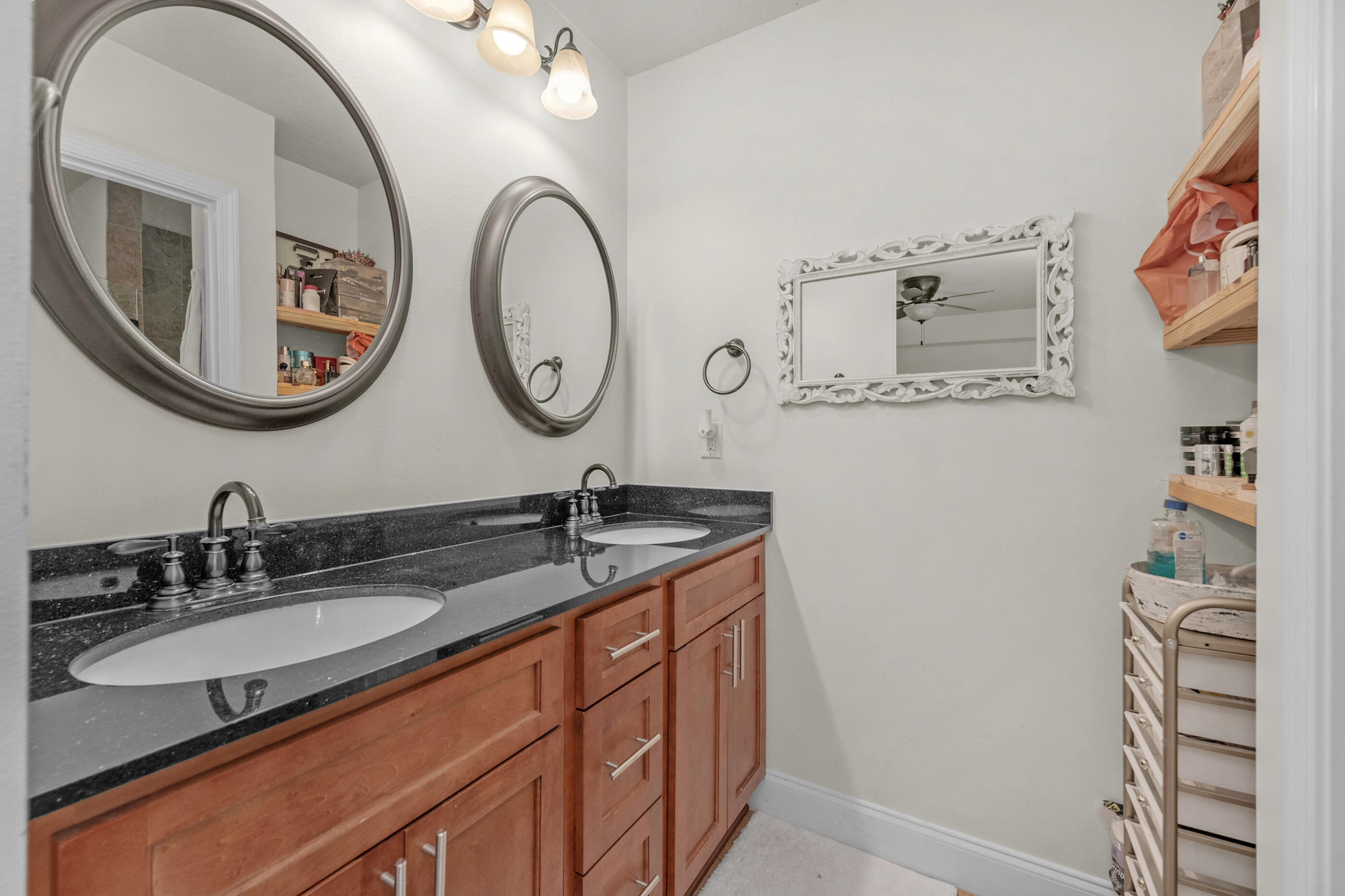 4509 Beth Circle Crestview, FL 32539 - Photo 20 of 29 a bathroom with a granite countertop sink and a mirror