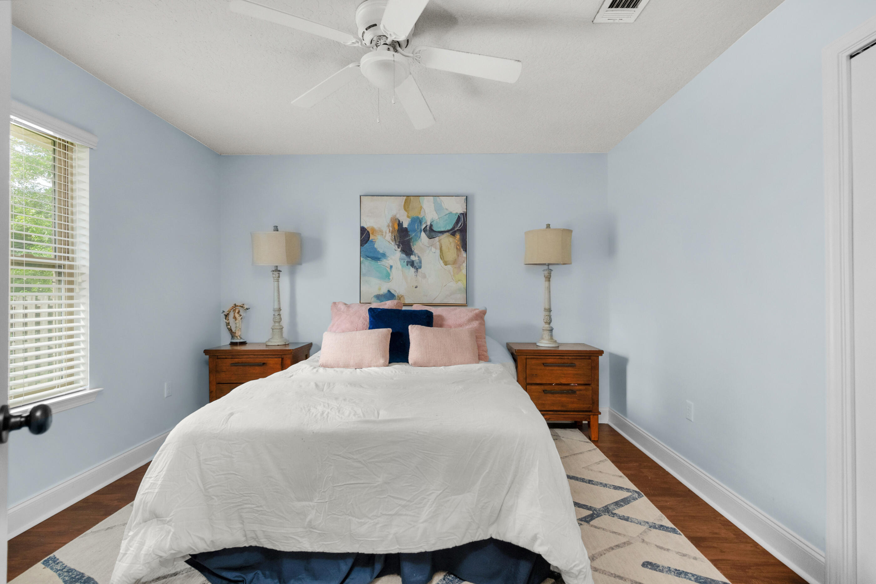 4509 Beth Circle Crestview, FL 32539 - Photo 24 of 29 a bedroom with a bed and a chandelier