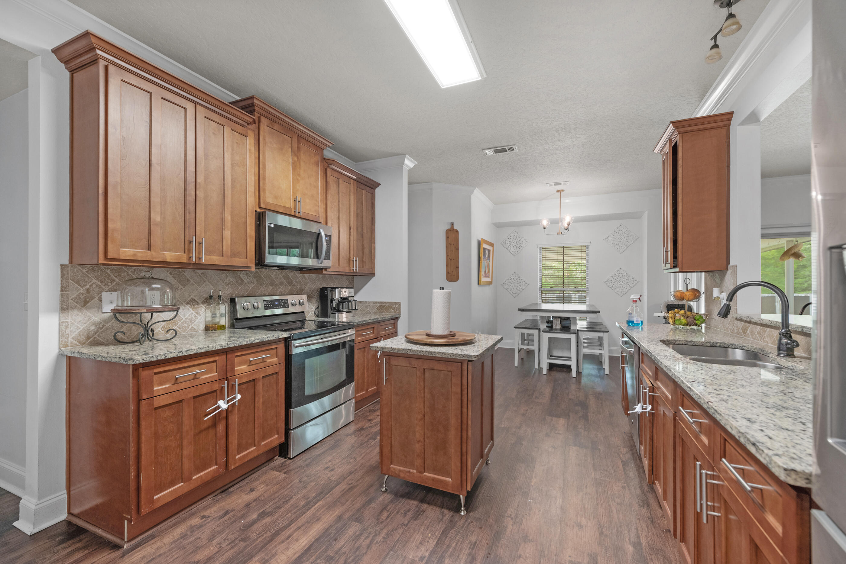 4509 Beth Circle Crestview, FL 32539 - Photo 4 of 29 a kitchen with lots of counter top space and wooden floor