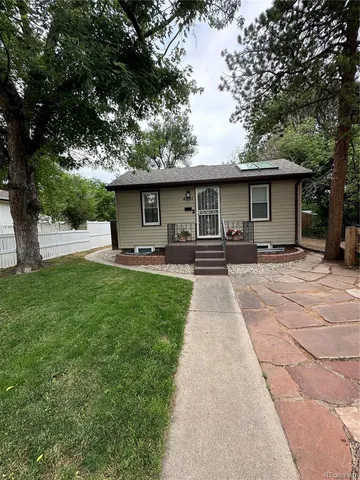 a front view of house with yard and green space
