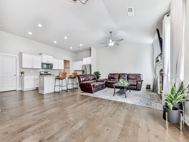 a living room with furniture and kitchen view