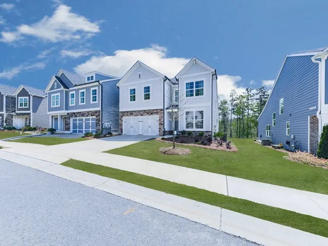 a front view of a house with a yard and porch